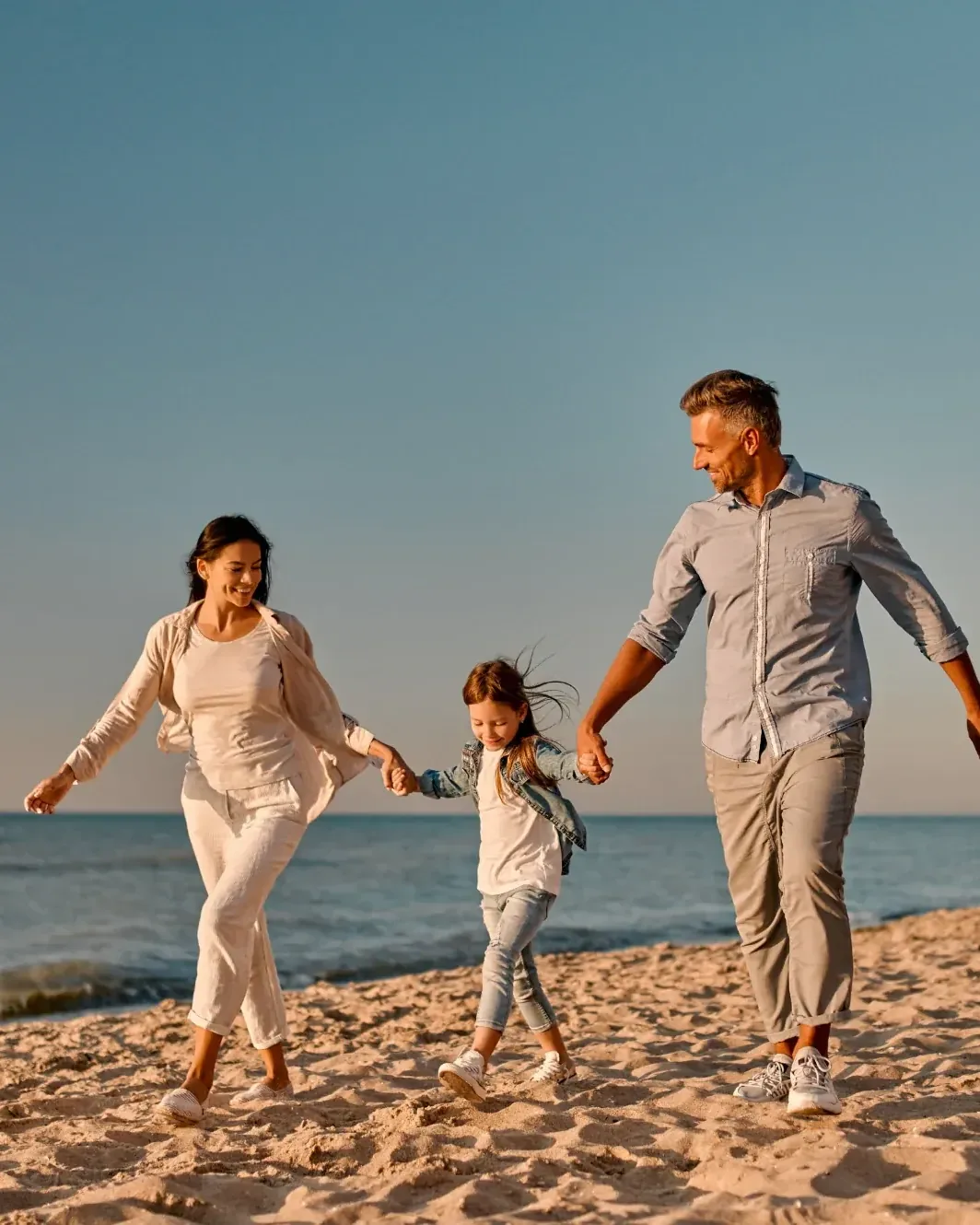 Family walking together on the beach